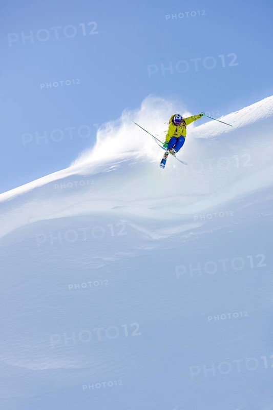 Freerider jumping off snow cornice