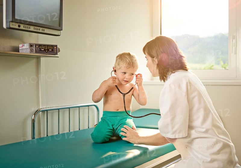 Pediatrician examining boy