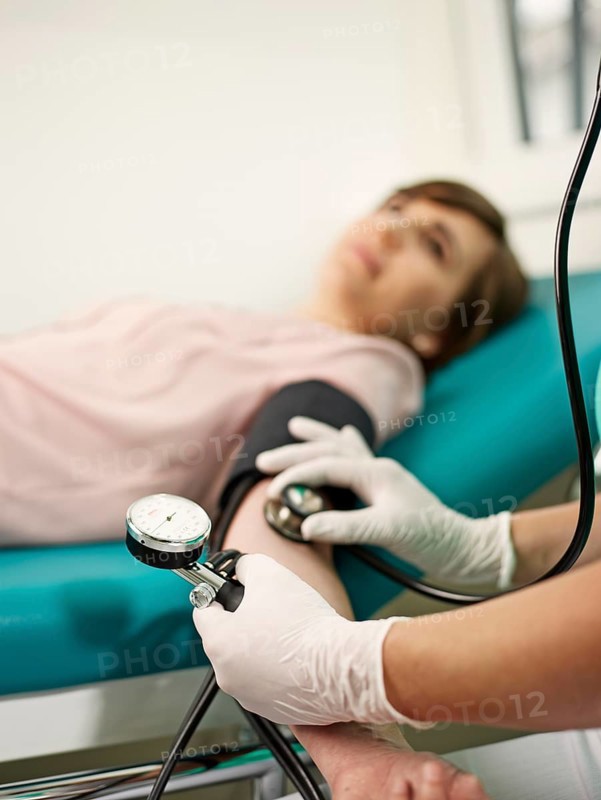 Nurse measuring patient's blood pressure