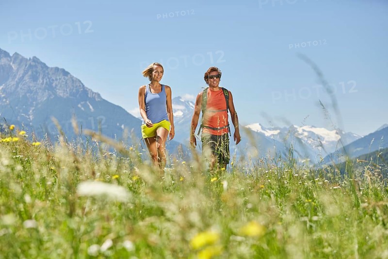 Man and woman walking in a meadow