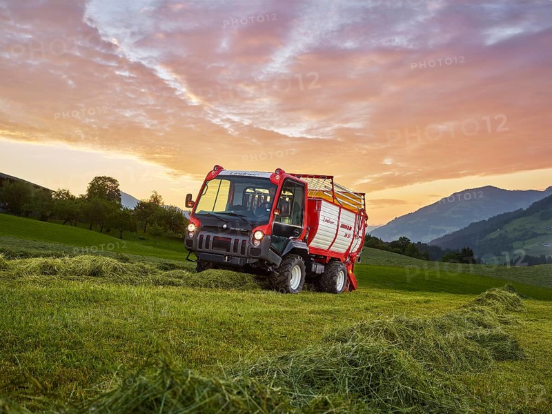 Unitrac transporter with forage trailer collecting the dried grass