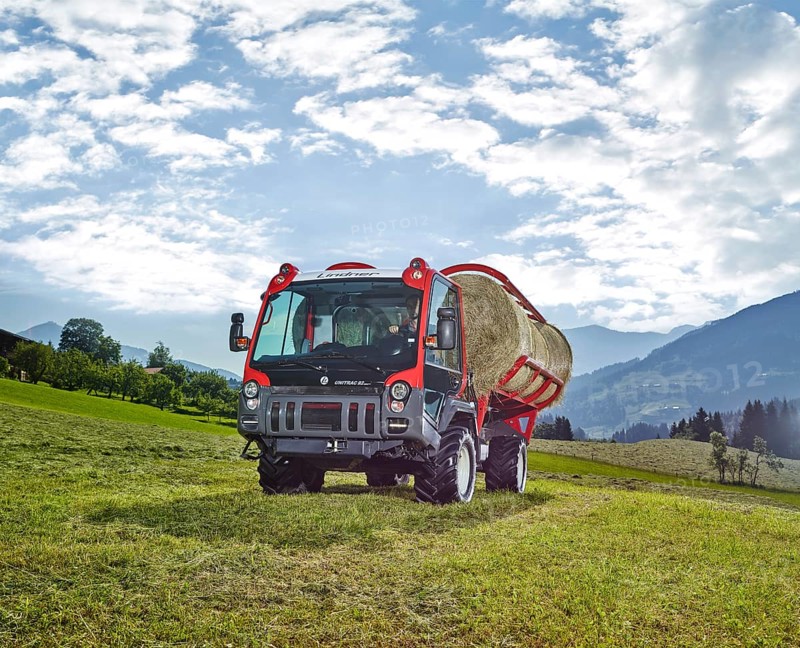 Unitrac transporter with forage trailer and a hay bale