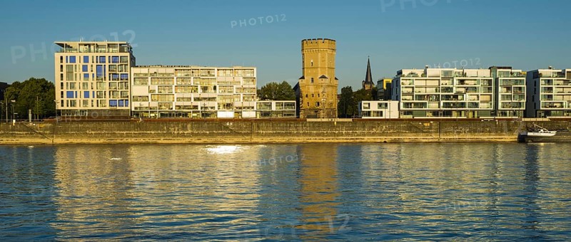 Houses with Bayenturm defence tower by the river Rhein