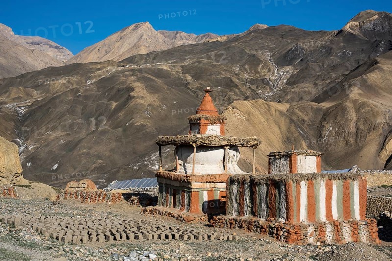Buddhist stupas in front of mountain landscape