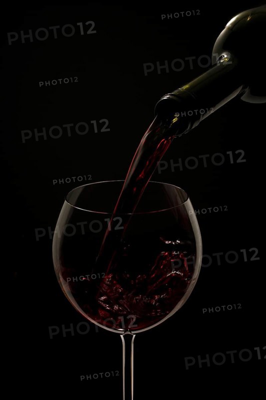 Red wine being poured into a glass