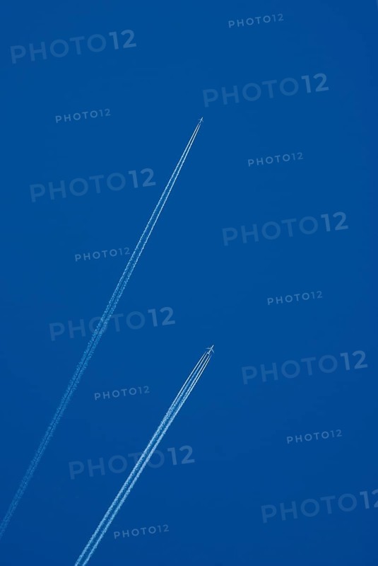 Contrails of two aircrafts in a blue sky