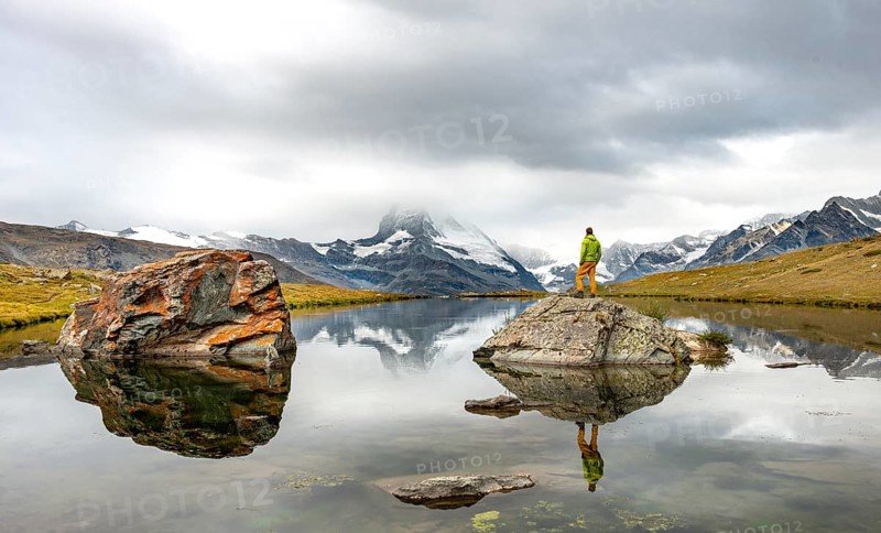 Hiker standing on rocks in the lake