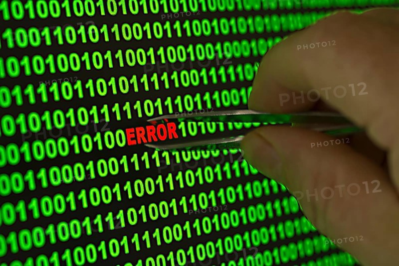 Hand reaching for the word 'Error' with tweezers in a binary code