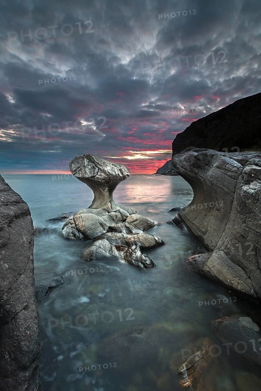 Kannestein or Kanne Stone with coastline at sunset