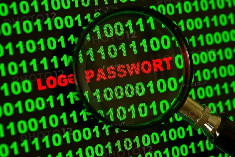 Binary code with the words 'Login Passwort' viewed through a magnifying glass