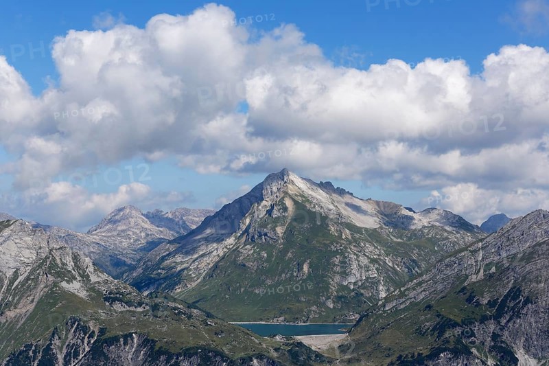 Lechquellen Mountains with Spuller Schafberg mountain and lake Spullersee seen from Burtschakopf mountain