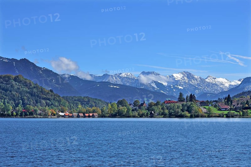 Snow-covered Oberstdorf Mountains behind Buhl am Alpsee with Alpsee lake