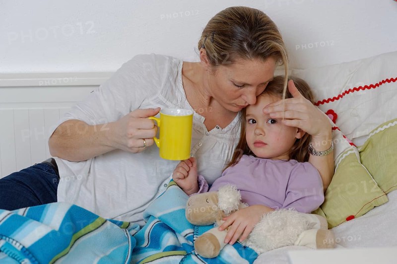Mother taking care of her sick daughter