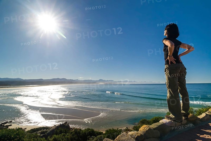 Young woman looking at a bay and the Indian Ocean