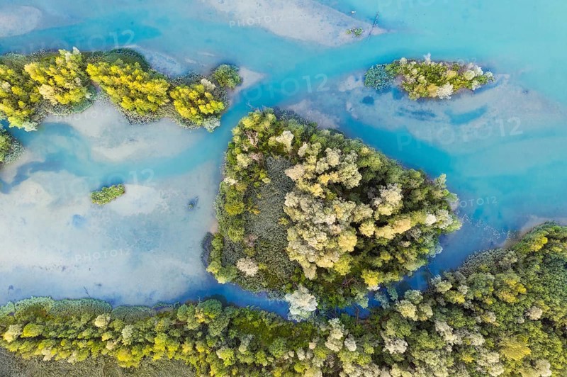 Wooded small islands in the Isar reservoir Tolz