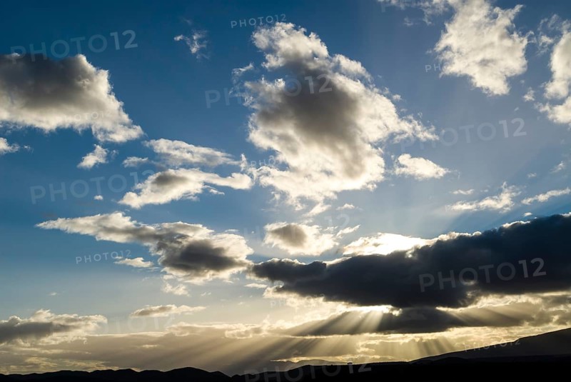 Sun rays breaking through the clouds in the evening light