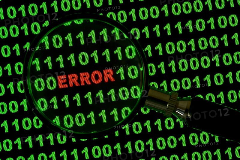 Binary code with the word 'Error' viewed through a magnifying glass