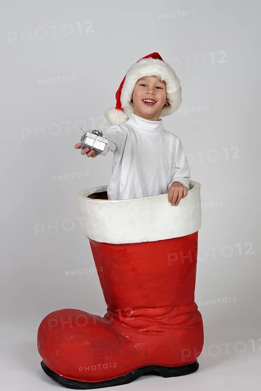 Boy with small gift in a Christmas boot