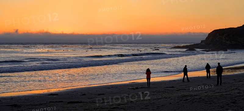 People at sunset at the Pacific beach of Cambria