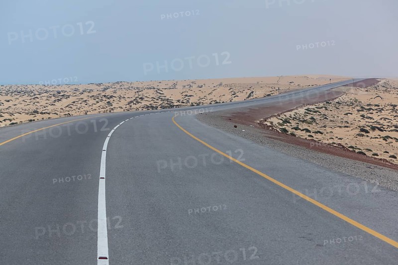 Omani highway through the sand desert