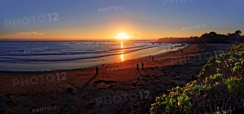 People at sunset at the Pacific beach of Cambria