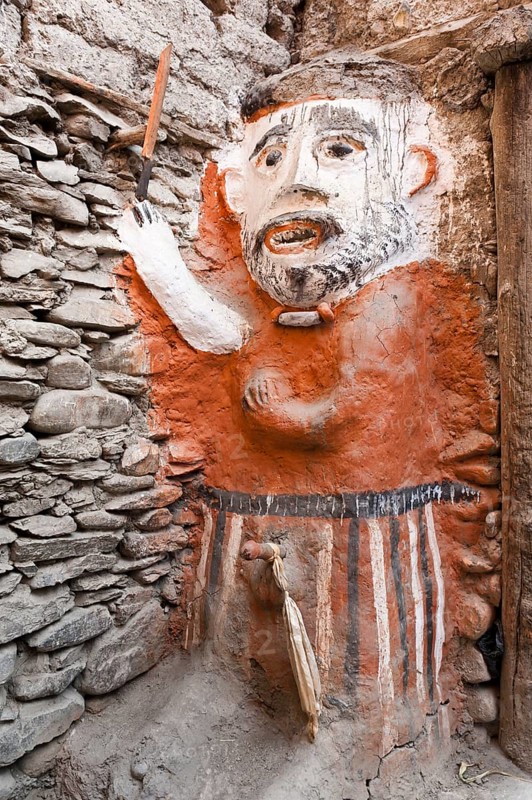 Animistic figure as a guard at the entrance to a house