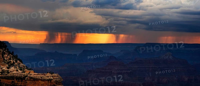 View of the Grand Canyon at sunset with storm clouds