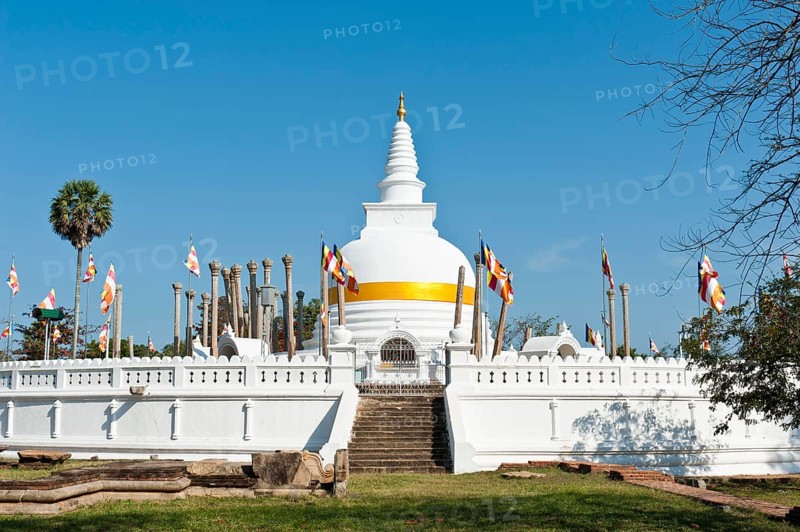 Old white stupa with orange ribbon