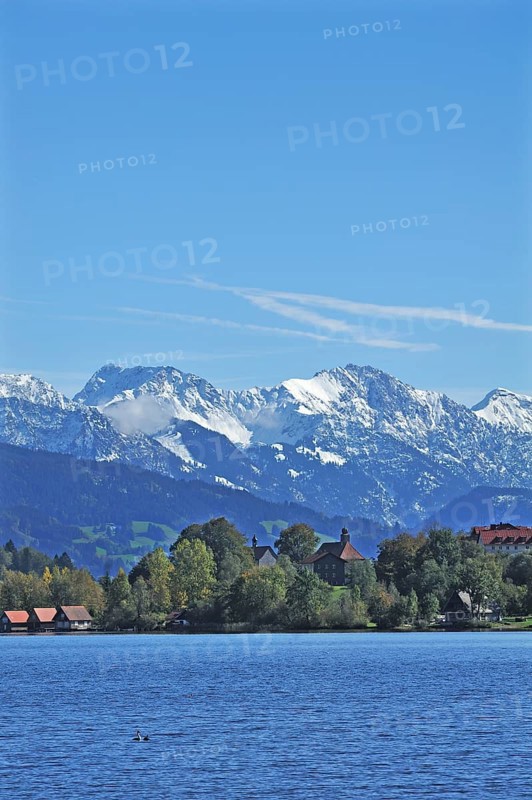 Snow-covered Oberstdorf Mountains behind Buhl am Alpsee with Alpsee lake