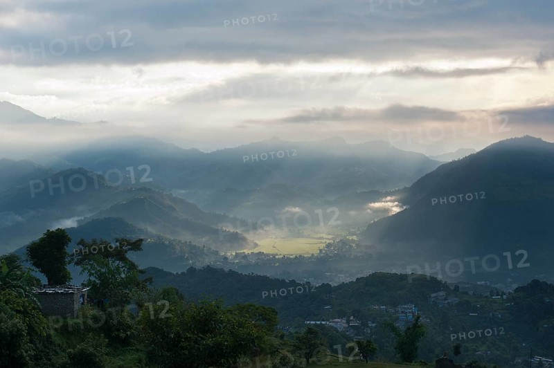 First sun rays of the morning filtering through the mist