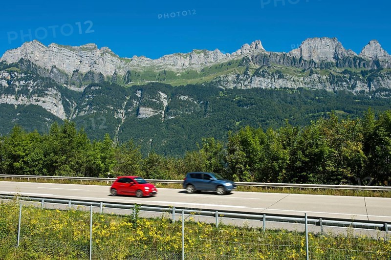 Vehicles on the A3 motorway in front of the Churfirsten range near Lake Walen