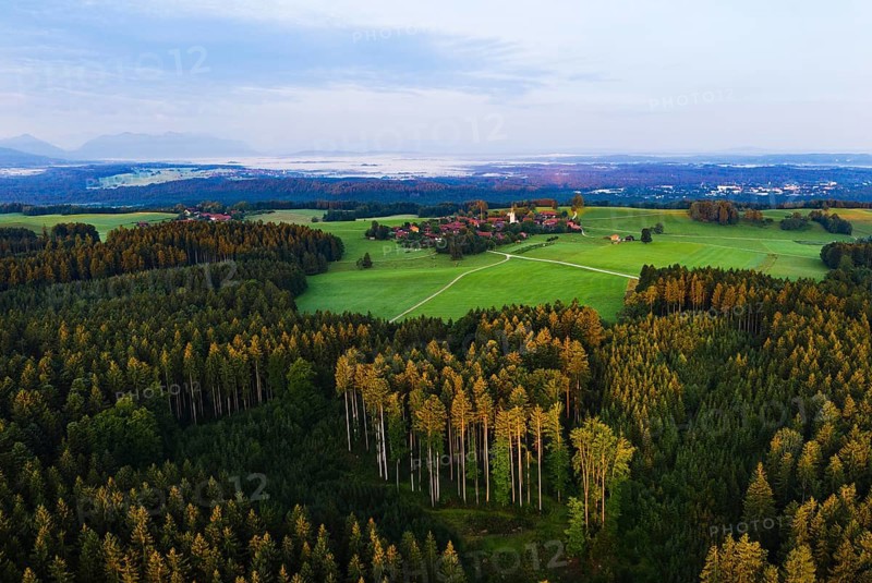 Forest with village Peretshofen near Dietramszell