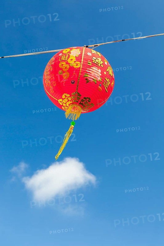 Red Chinese New Year lantern against blue sky