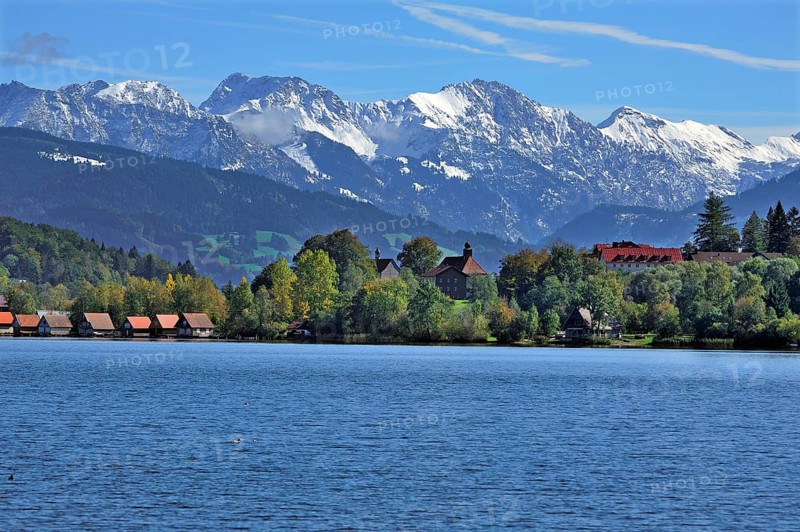 Snow-covered Oberstdorf Mountains behind Buhl am Alpsee with Alpsee lake