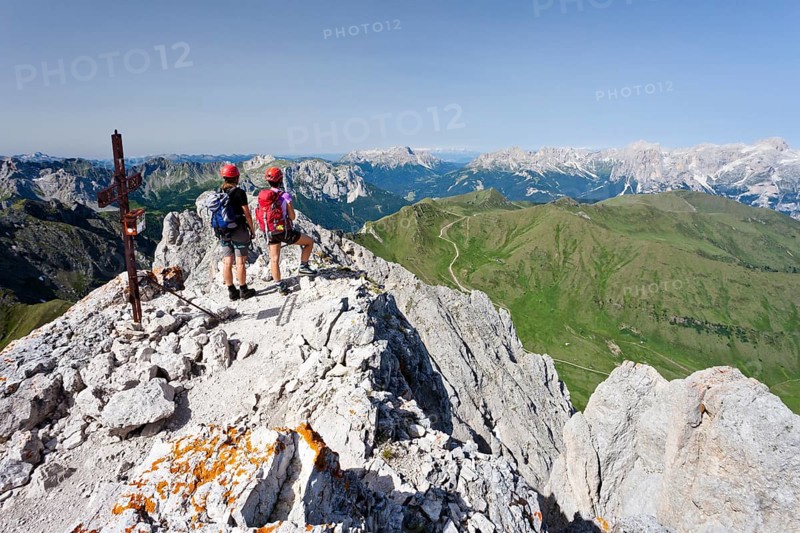 Climber on the summit of Colac on the Via Ferrata dei Finanzieri in Val di Fassa