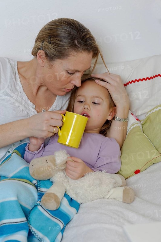 Mother taking care of her sick daughter