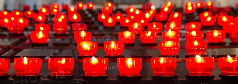 Burning votive candles in a church