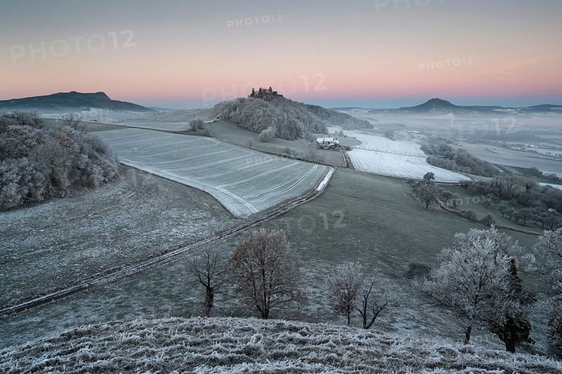 Hoar frost covered fields and meadows in Hegau with the Hohenstoffeln Mountain