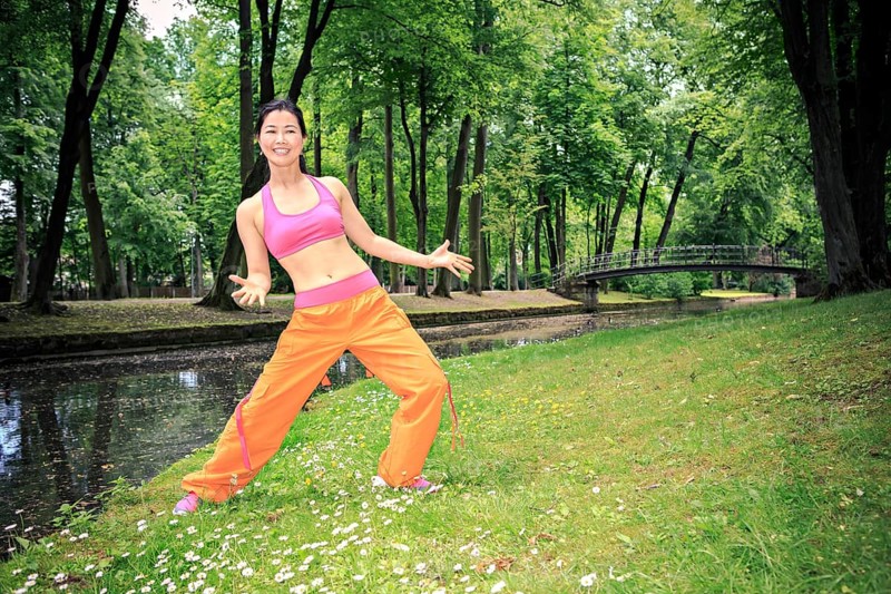 Woman dancing zumba in a park