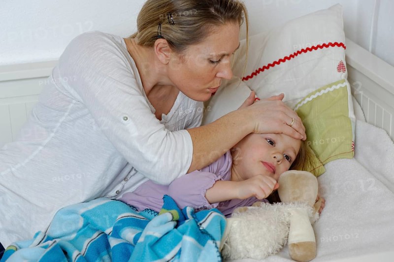 Mother taking care of her sick daughter