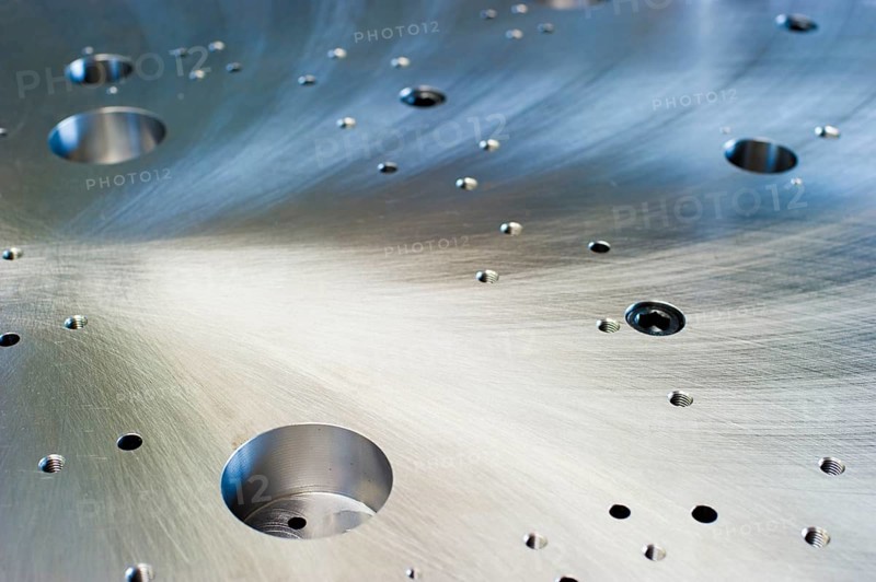 Cut metal surface with drilled holes