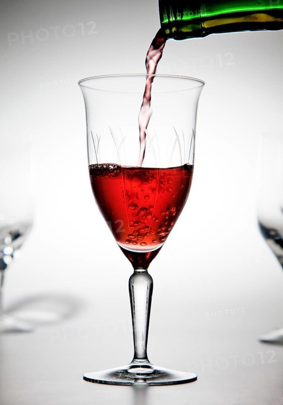 Red wine being poured into a wine glass