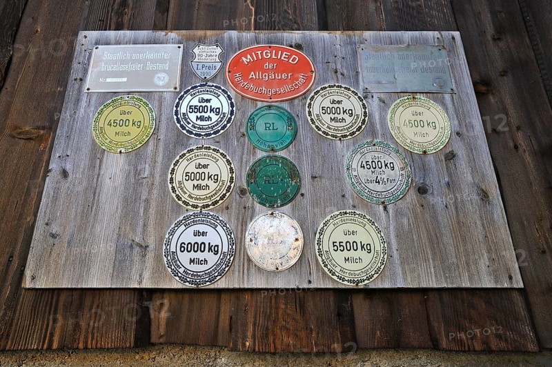 Panel with award plaques for milk yield on a cowshed