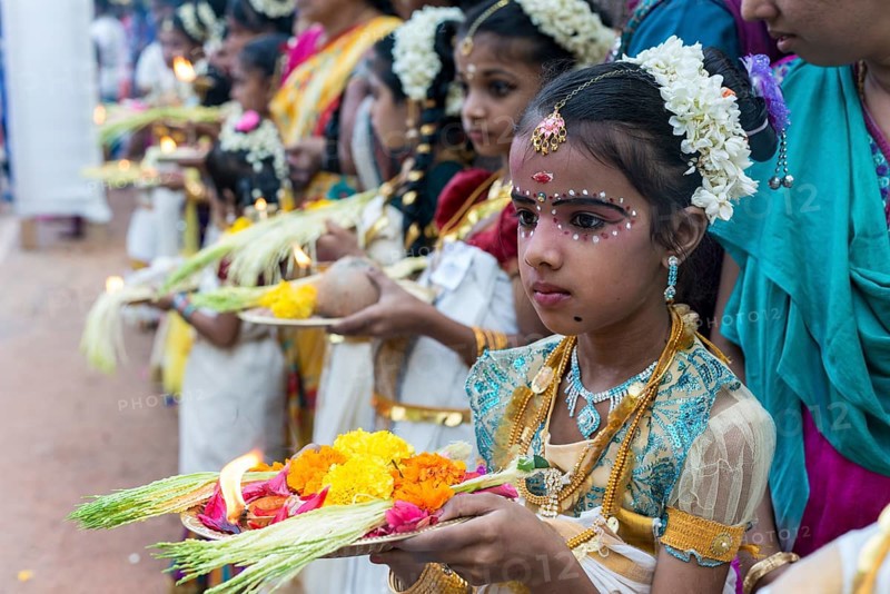 Girl offering flowers at a temple festival