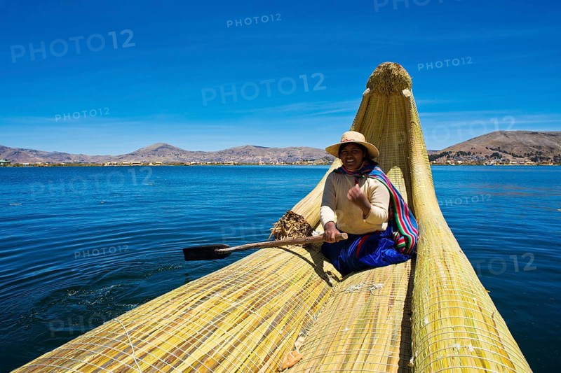 Local in a traditional rowing boat of Totora reed on Lake Titicaca