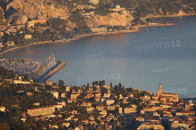 Menton with the port of Garavan and the border to Italy in the evening light