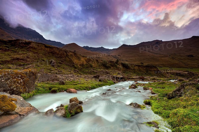 Mountain stream with the peaks of El Altar or Kapak Urku