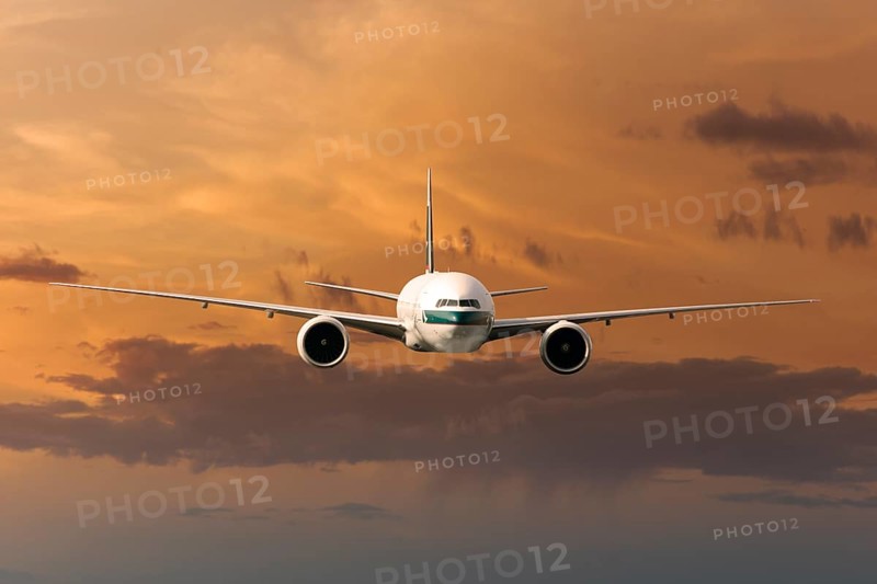 Cathay Pacific Boeing 777-367 ER in flight in the evening light