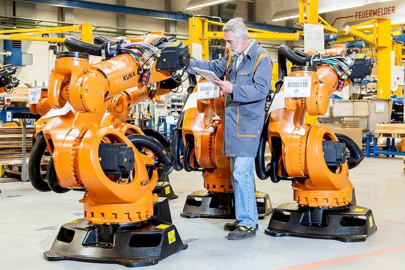 Employee of the robot manufacturer KUKA AG completing the shipping documents before delivery of KUKA robots