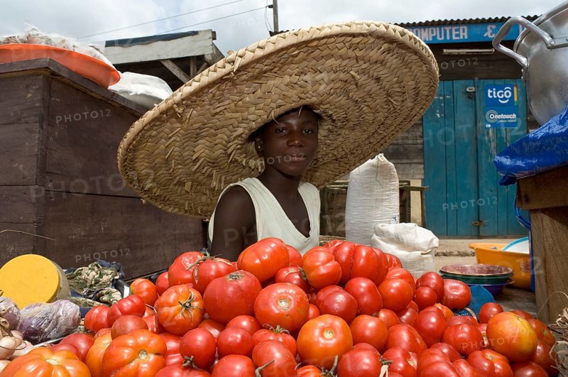 Girl selling tomatoes on a market